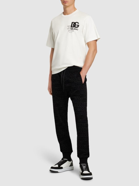 Dolce&Gabbana: Pantaloni in jersey di cotone con logo floccato - Nero - men_1 | Luisa Via Roma