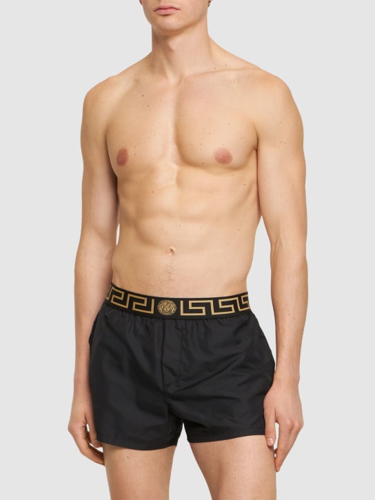 Versace: Monogram waistband tech swim shorts - Black/Gold - men_1 | Luisa Via Roma