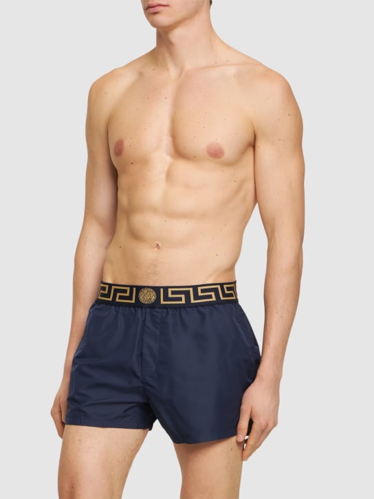 Versace: Monogram waistband tech swim shorts - Blue/Gold - men_1 | Luisa Via Roma