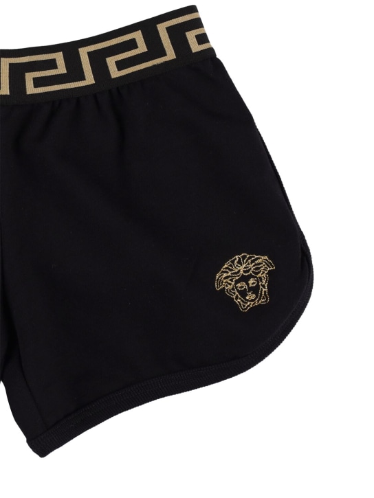 Versace: Shorts de jersey de algodón bordados - Negro/Dorado - kids-girls_1 | Luisa Via Roma