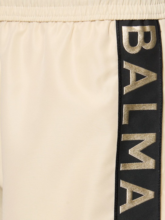 Balmain: Balmain logo tech swim shorts - Ivory/Black - men_1 | Luisa Via Roma
