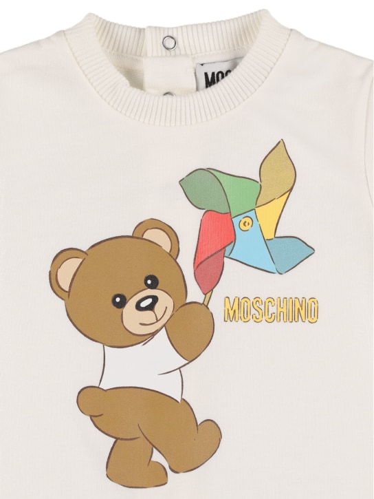 Moschino: Tutina, cuffietta e bavaglio in jersey di cotone - Off-White - kids-boys_1 | Luisa Via Roma