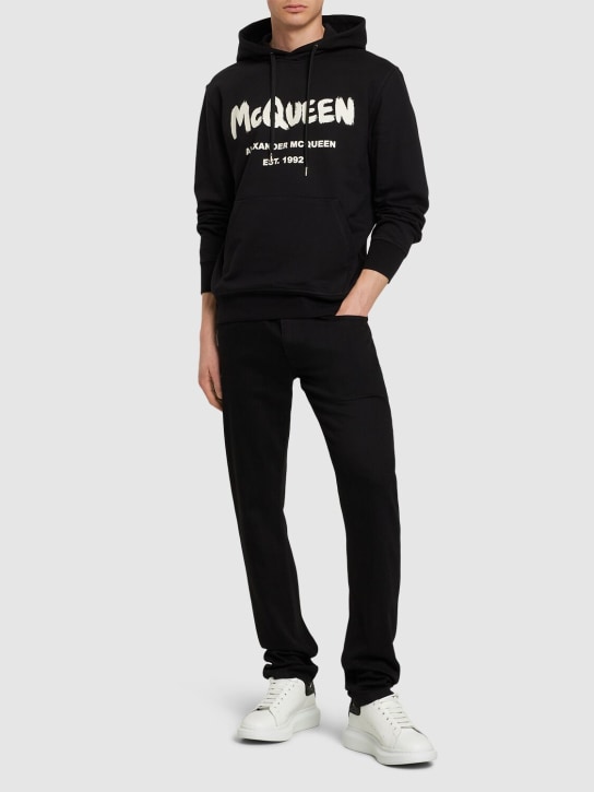 Alexander McQueen: Graffiti cotton denim slim fit jeans - Black - men_1 | Luisa Via Roma