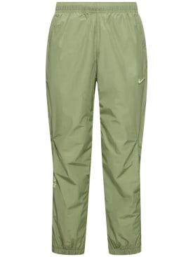 Nike: Nocta woven track pants - Oil Green/Lime - men_0 | Luisa Via Roma