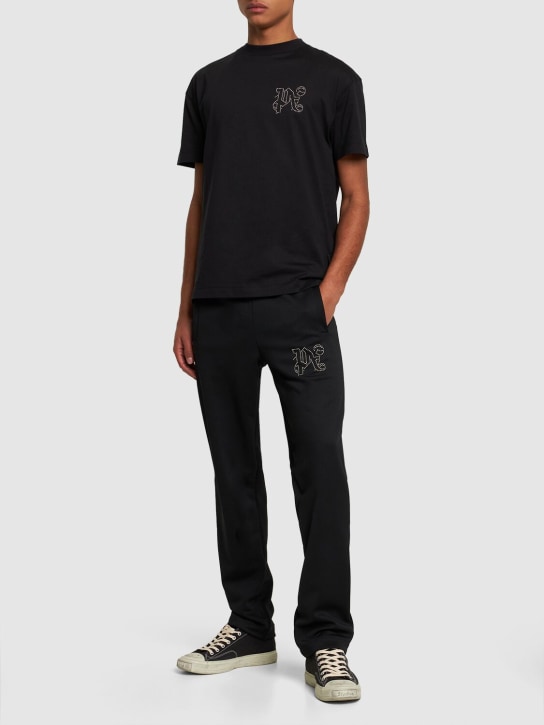 Palm Angels: Monogram Stud cotton t-shirt - Siyah - men_1 | Luisa Via Roma