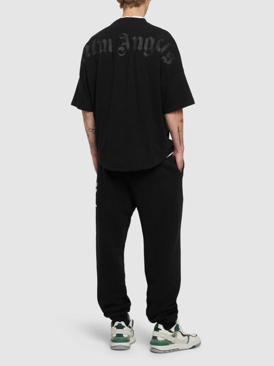 Palm Angels: T-shirt oversize in cotone con logo e glitter - Nero - men_1 | Luisa Via Roma