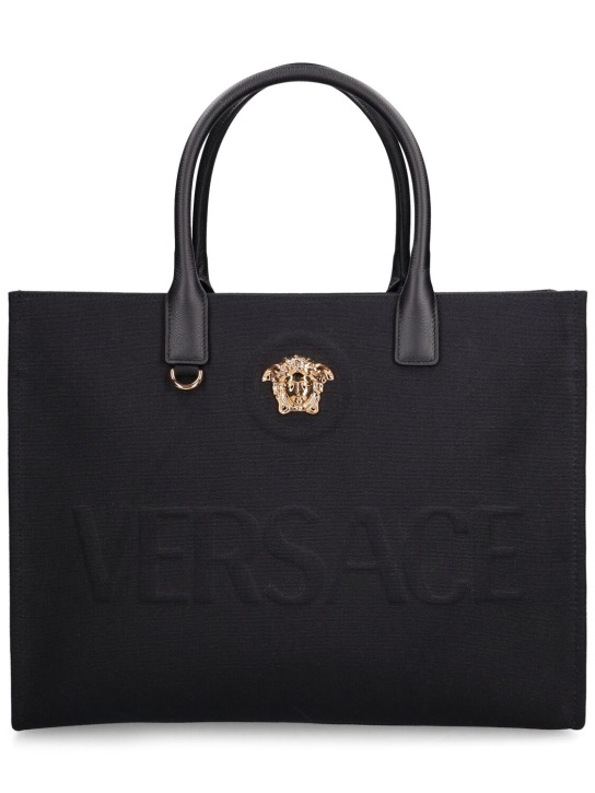 Versace: Tote aus Baumwollcanvas mit Logodruck - Schwarz/Gold - women_0 | Luisa Via Roma