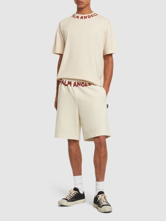 Palm Angels: Pantaloni in felpa di cotone con logo - Off-White - men_1 | Luisa Via Roma