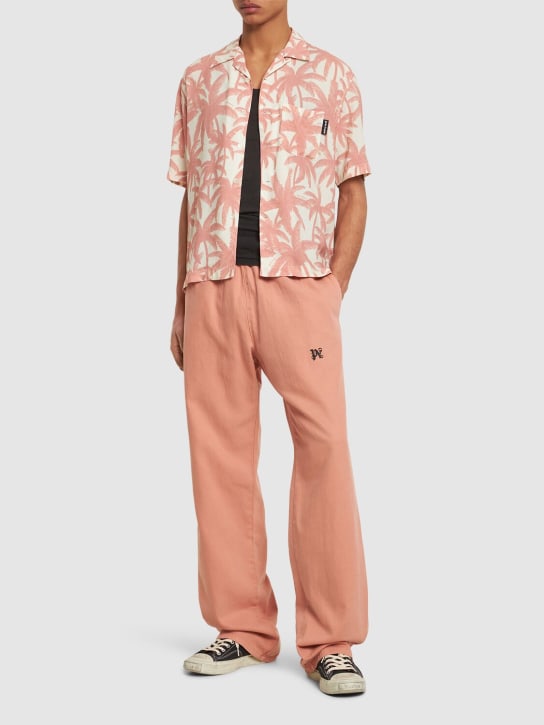 Palm Angels: Monogram cotton travel sweatpants - Pink - men_1 | Luisa Via Roma