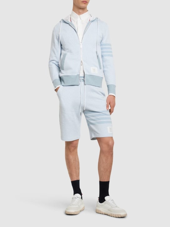 Thom Browne: Cotton & silk sweat shorts w/bars - Light Blue - men_1 | Luisa Via Roma