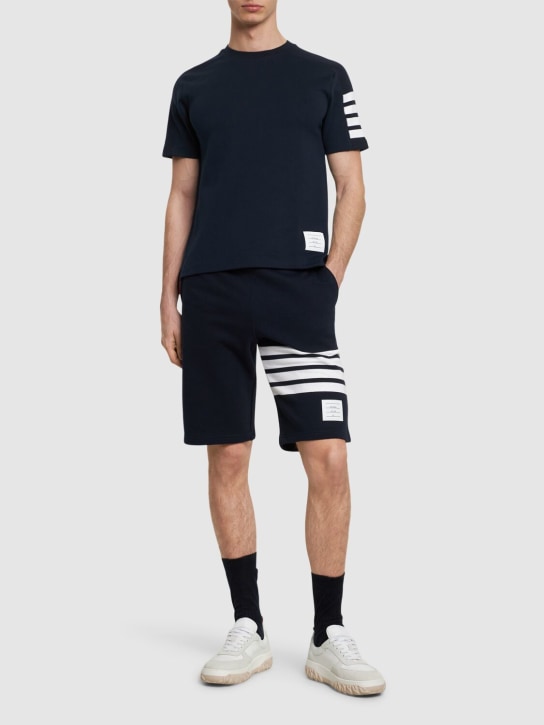 Thom Browne: Cotton ss t-shirt w/ 4 bar stripe - Navy - men_1 | Luisa Via Roma