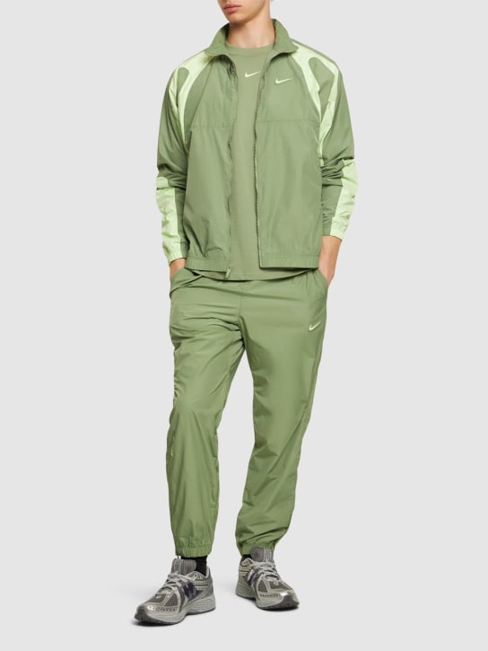 Nike: Nocta woven track jacket - Oil Green/Lime - men_1 | Luisa Via Roma