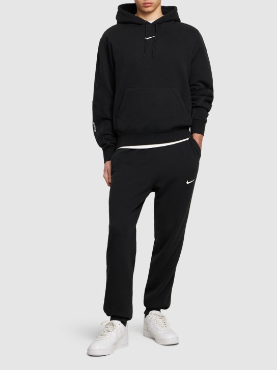 Nike: Pantalon en tissu Fleece Nocta - Noir/Blanc - men_1 | Luisa Via Roma