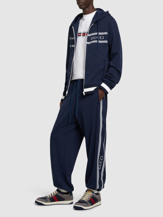 Gucci: Pantalon de sport en matière technique à logo - Bleu Marine - men_1 | Luisa Via Roma
