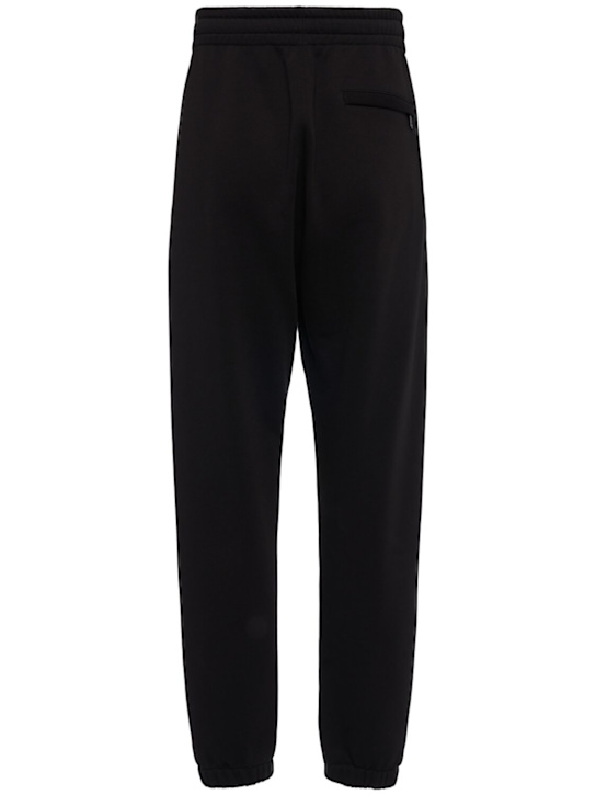 Dolce&Gabbana: Logo embossed jersey jogging pants - Black - men_1 | Luisa Via Roma