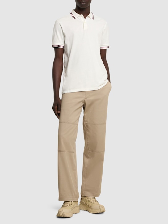 Moncler: Polo in cotone piqué con profili a righe - men_1 | Luisa Via Roma
