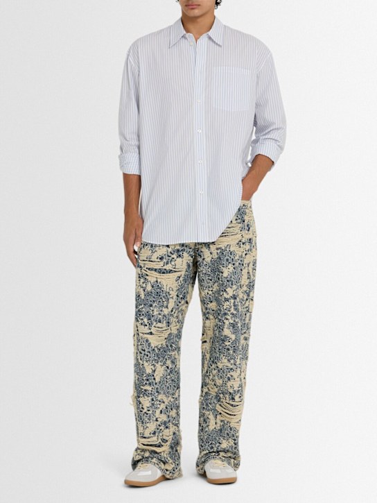 Acne Studios: 1981 Distressed monogram jeans - Mid Blue - men_1 | Luisa Via Roma