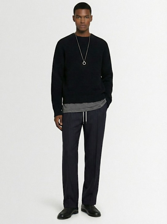 Maison Margiela: Pinstriped wool pants - men_1 | Luisa Via Roma