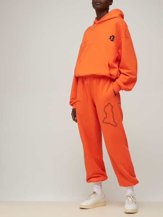 Pangaia: Pantaloni Pangaia x Extreme E in cotone - Arancione - women_1 | Luisa Via Roma