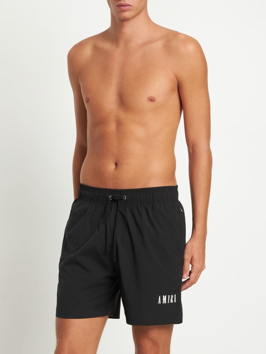 Amiri: Logo print tech swim shorts - men_1 | Luisa Via Roma