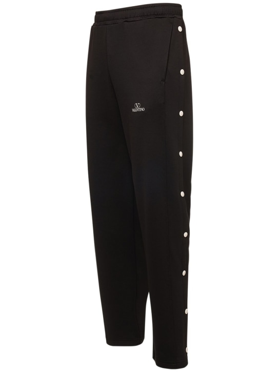 Valentino: Pantalones de felpa de mezcla de algodón con logo - Negro/Blanco - men_1 | Luisa Via Roma