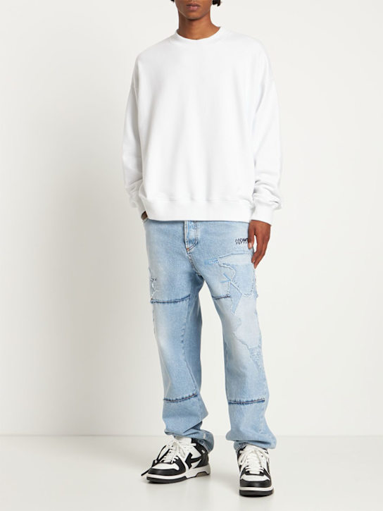 Marcelo Burlon County Of Milan: Loose distressed cotton denim jeans - Light Blue - men_1 | Luisa Via Roma