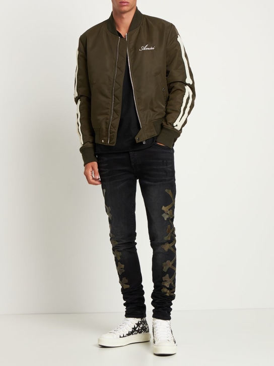 Amiri: Camo bones stretch denim jeans - Aged Black - men_1 | Luisa Via Roma