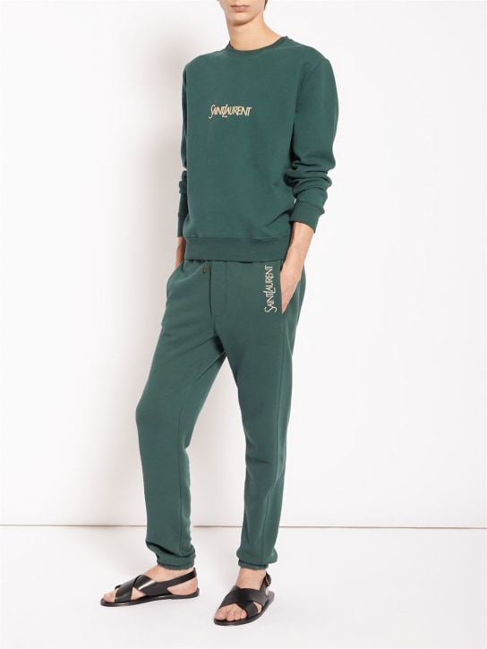 Saint Laurent: Pantalones de algodón con logo - Verde - men_1 | Luisa Via Roma
