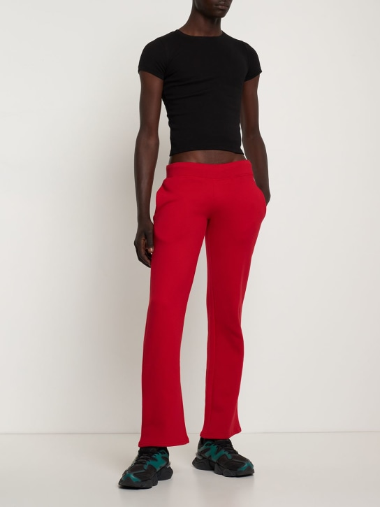 Mowalola: Logo print cotton jersey sweatpants - Red - men_1 | Luisa Via Roma