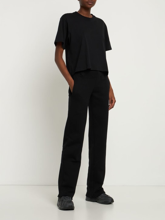 Mowalola: Logo print cotton jersey sweatpants - Black - women_1 | Luisa Via Roma