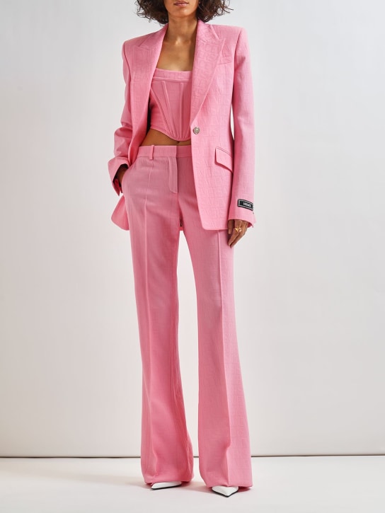Versace: Pantalon évasé en laine jacquard à logo - Rose - women_1 | Luisa Via Roma