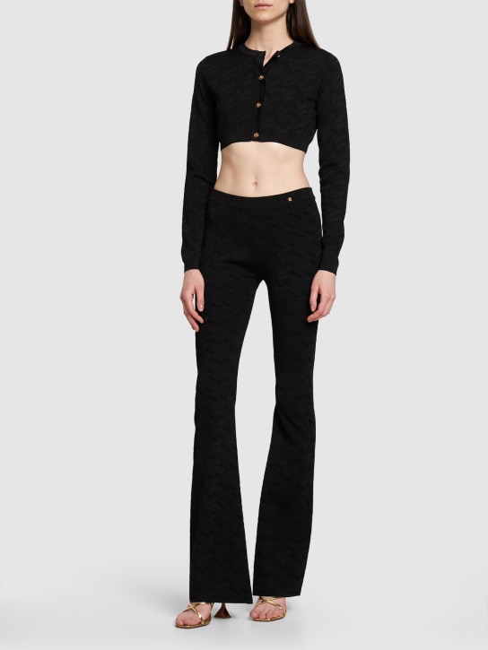Versace: Logo提花粘胶纤维针织喇叭裤 - 黑色 - women_1 | Luisa Via Roma