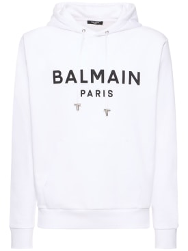Balmain: Sweat-shirt en coton imprimé logo à capuche - Blanc/Noir - men_0 | Luisa Via Roma