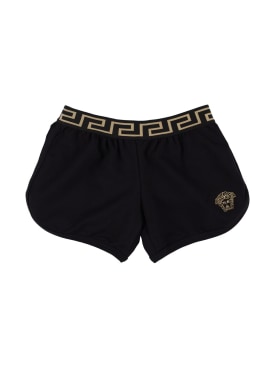 Versace: Shorts de jersey de algodón bordados - Negro/Dorado - kids-girls_0 | Luisa Via Roma