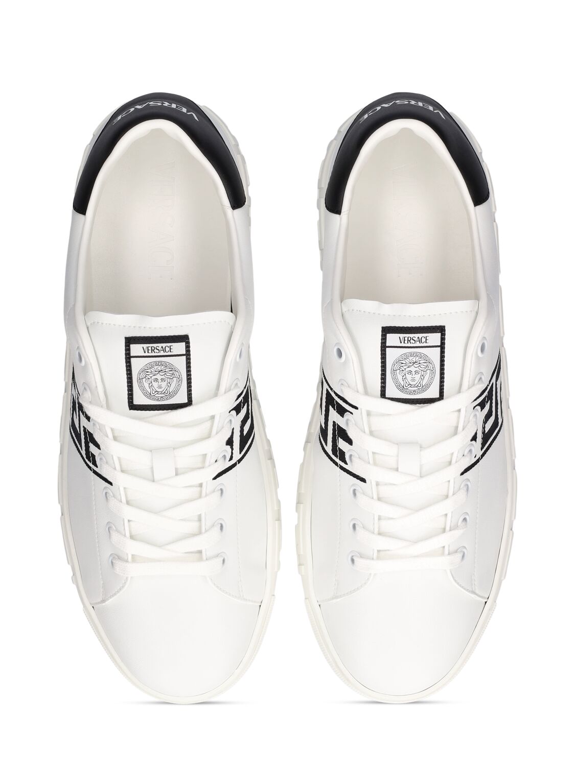 Shop Versace Faux Leather Logo Sneakers In White,black