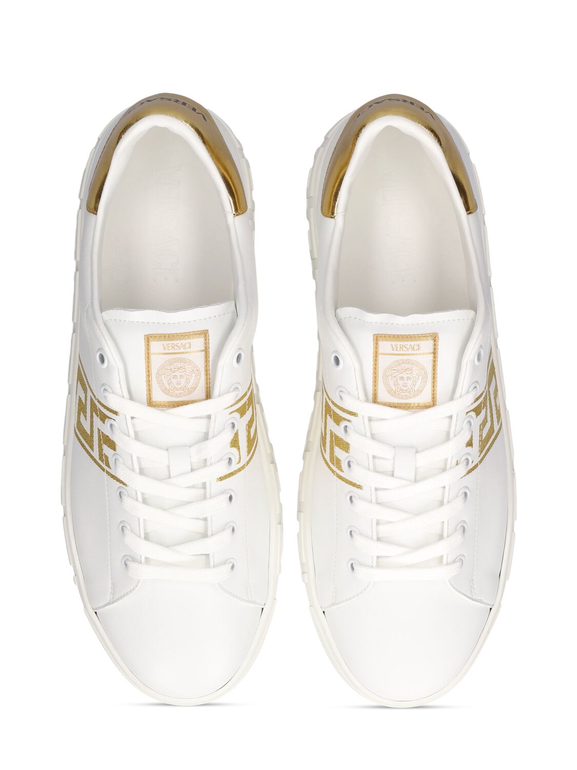 Shop Versace Faux Leather Logo Sneakers In White,gold