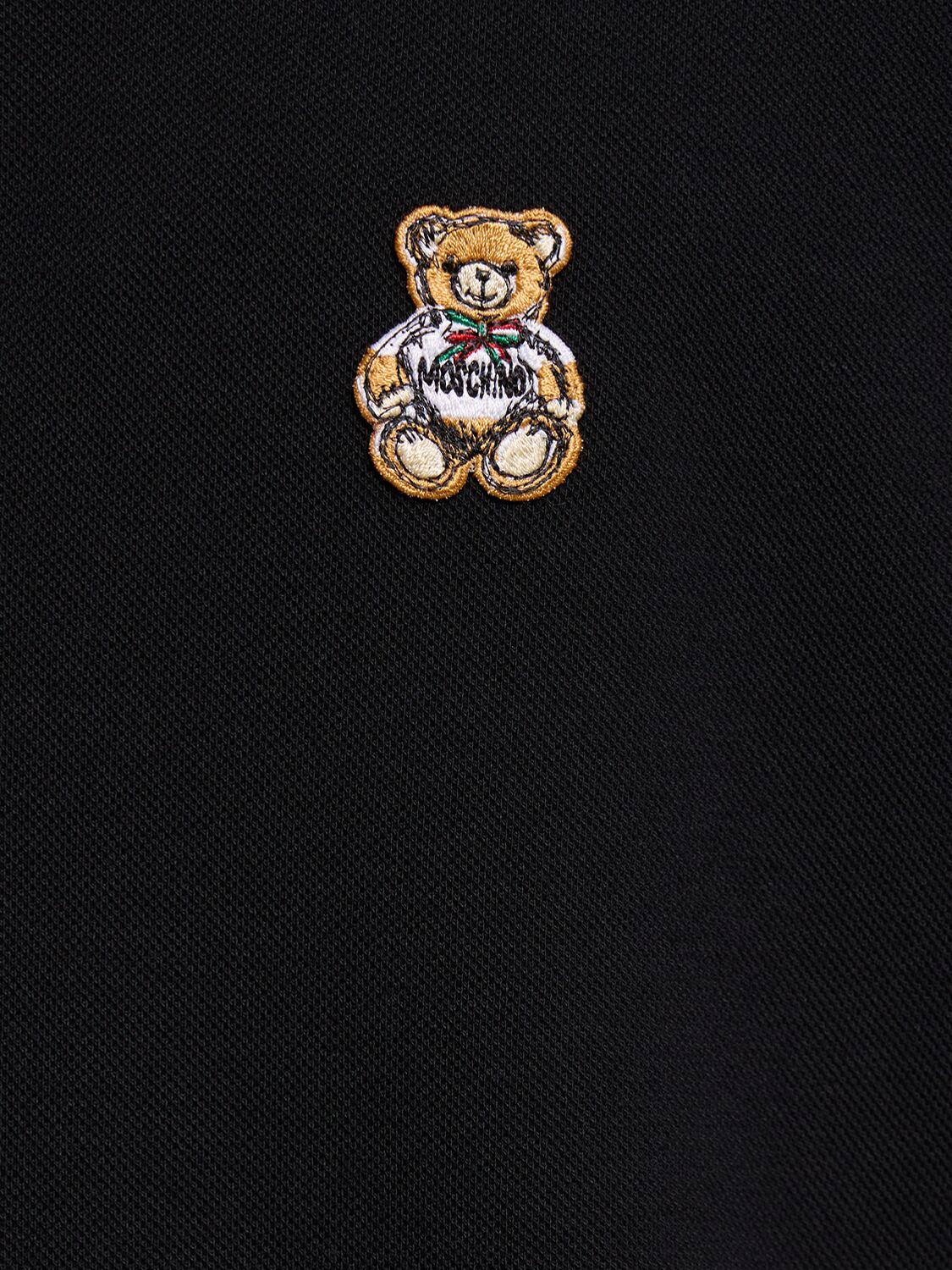 Shop Moschino Teddy Logo Patch Polo Shirt In 黑色