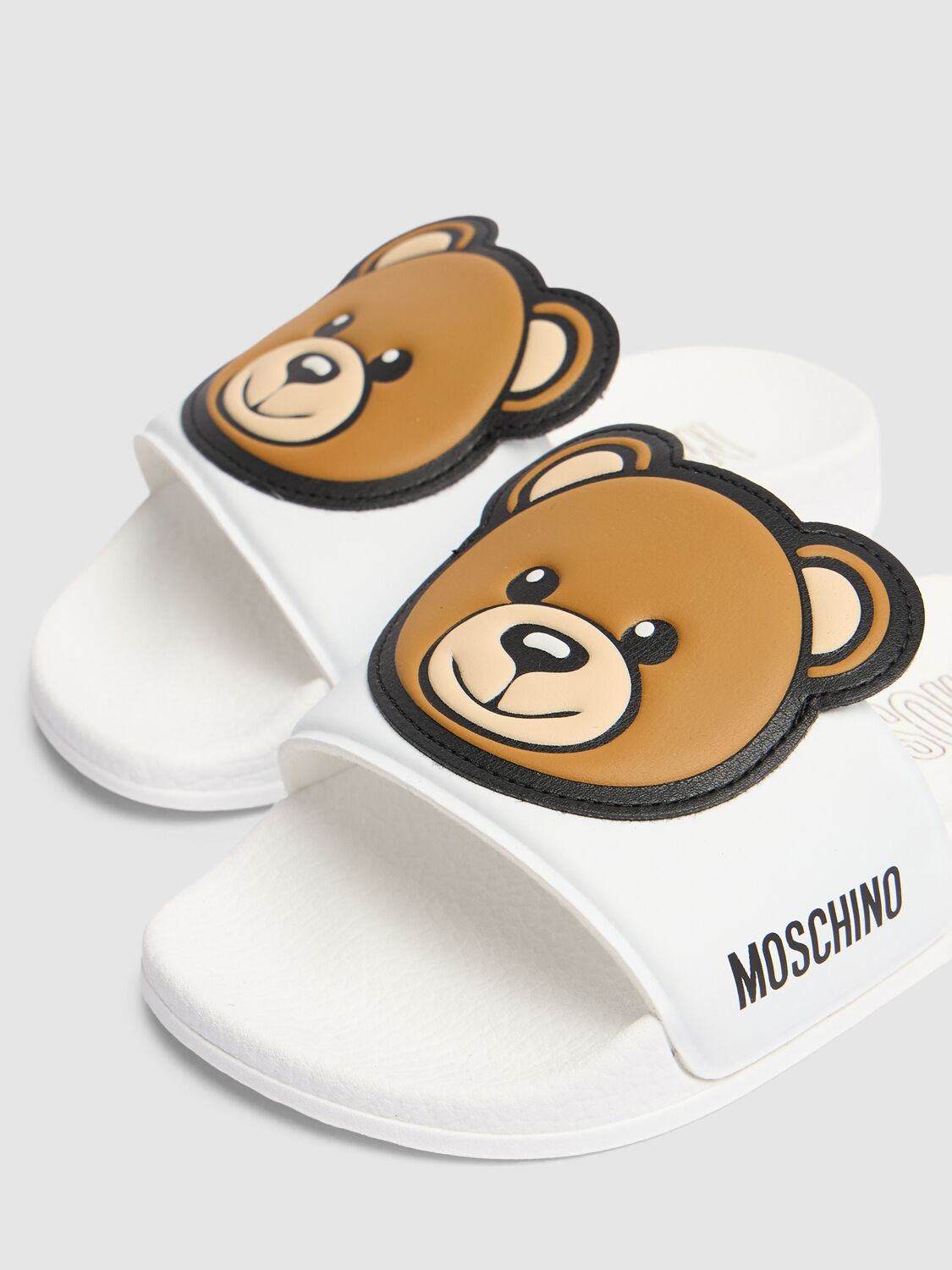 Shop Moschino Logo Print Rubber Slide Sandals W/ Patch In White