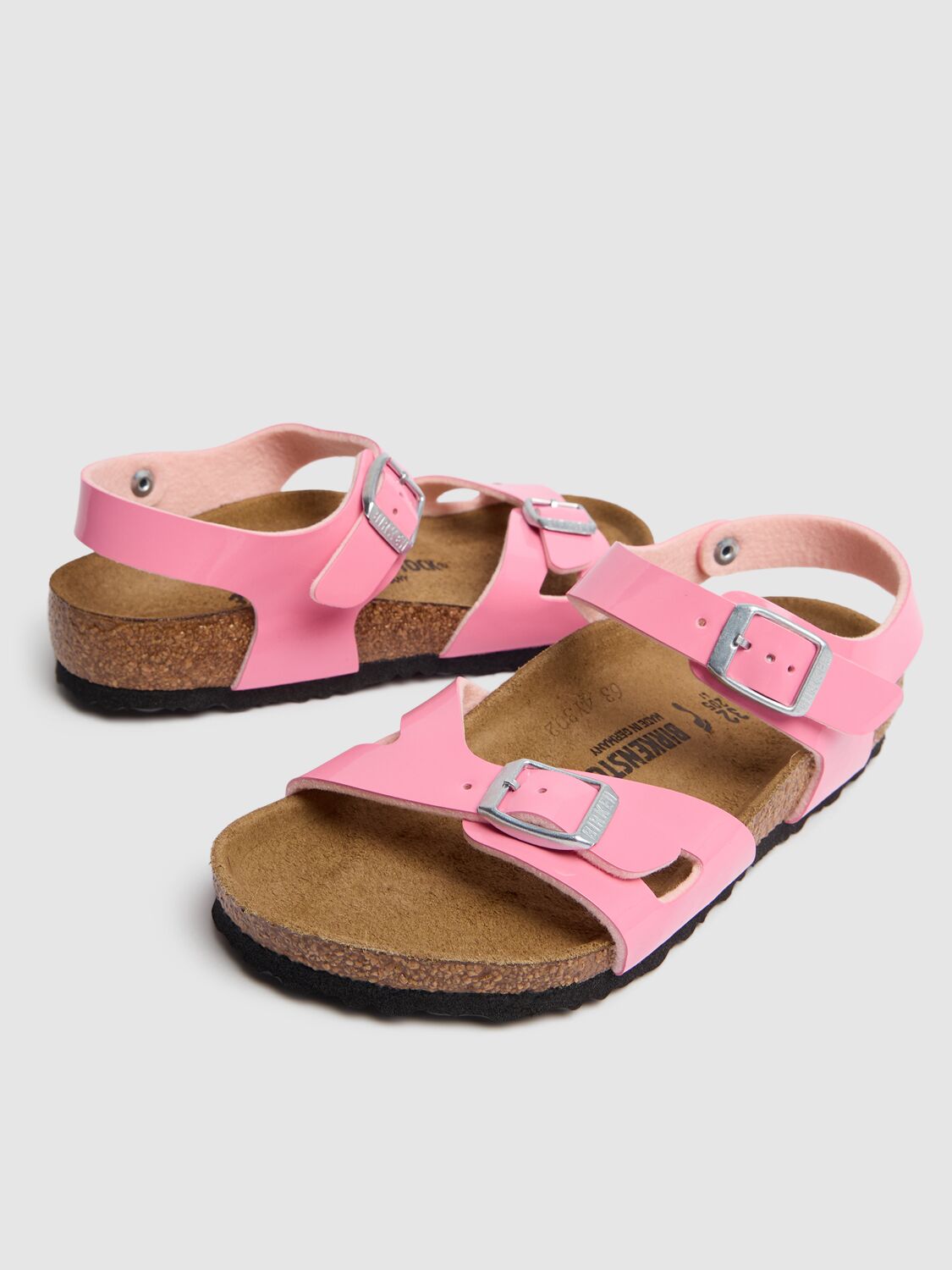 Shop Birkenstock Patent Rio Faux Leather Sandals In Pink