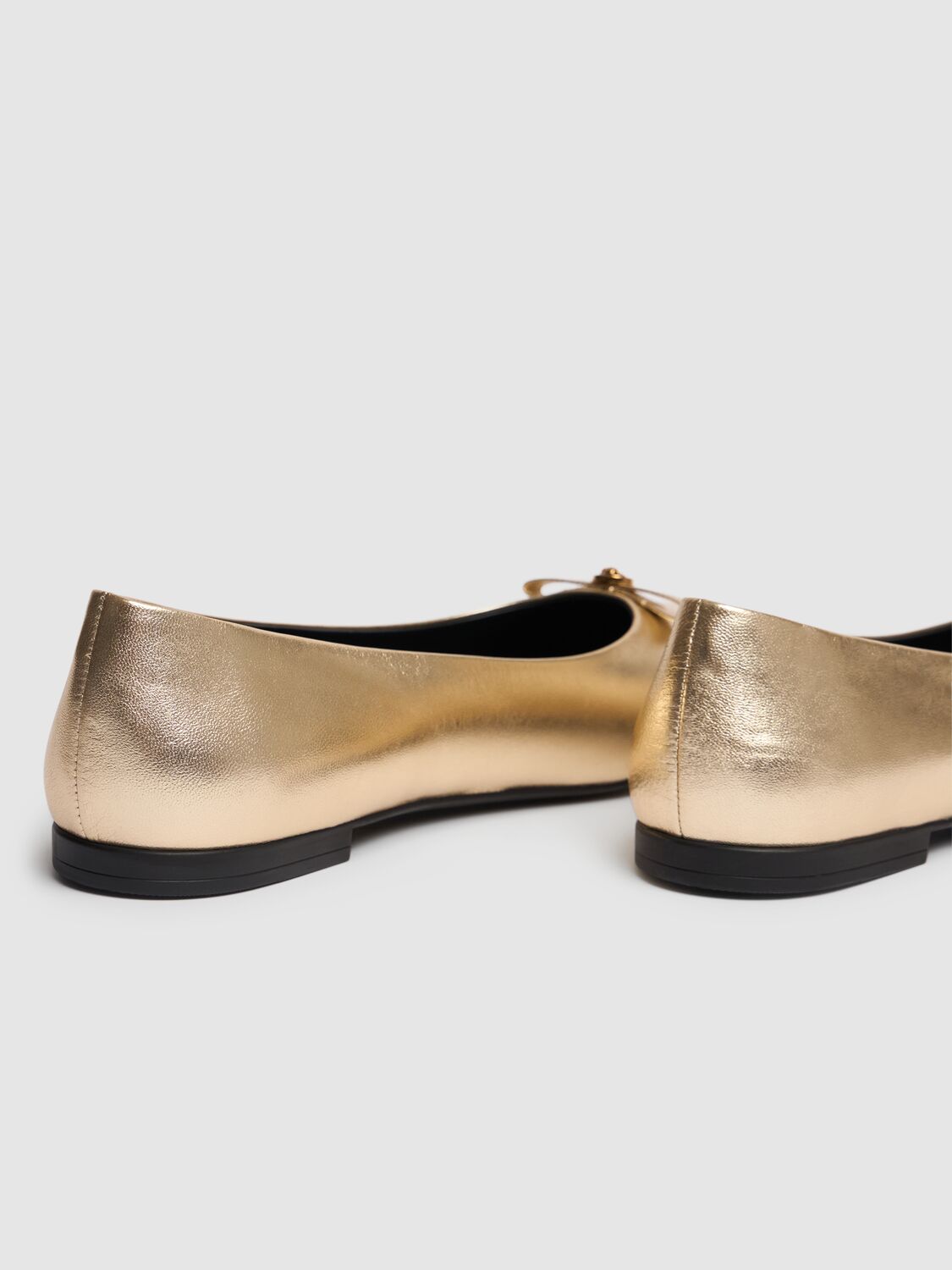 Shop Versace Metallic Leather Ballerinas W/bow In Gold