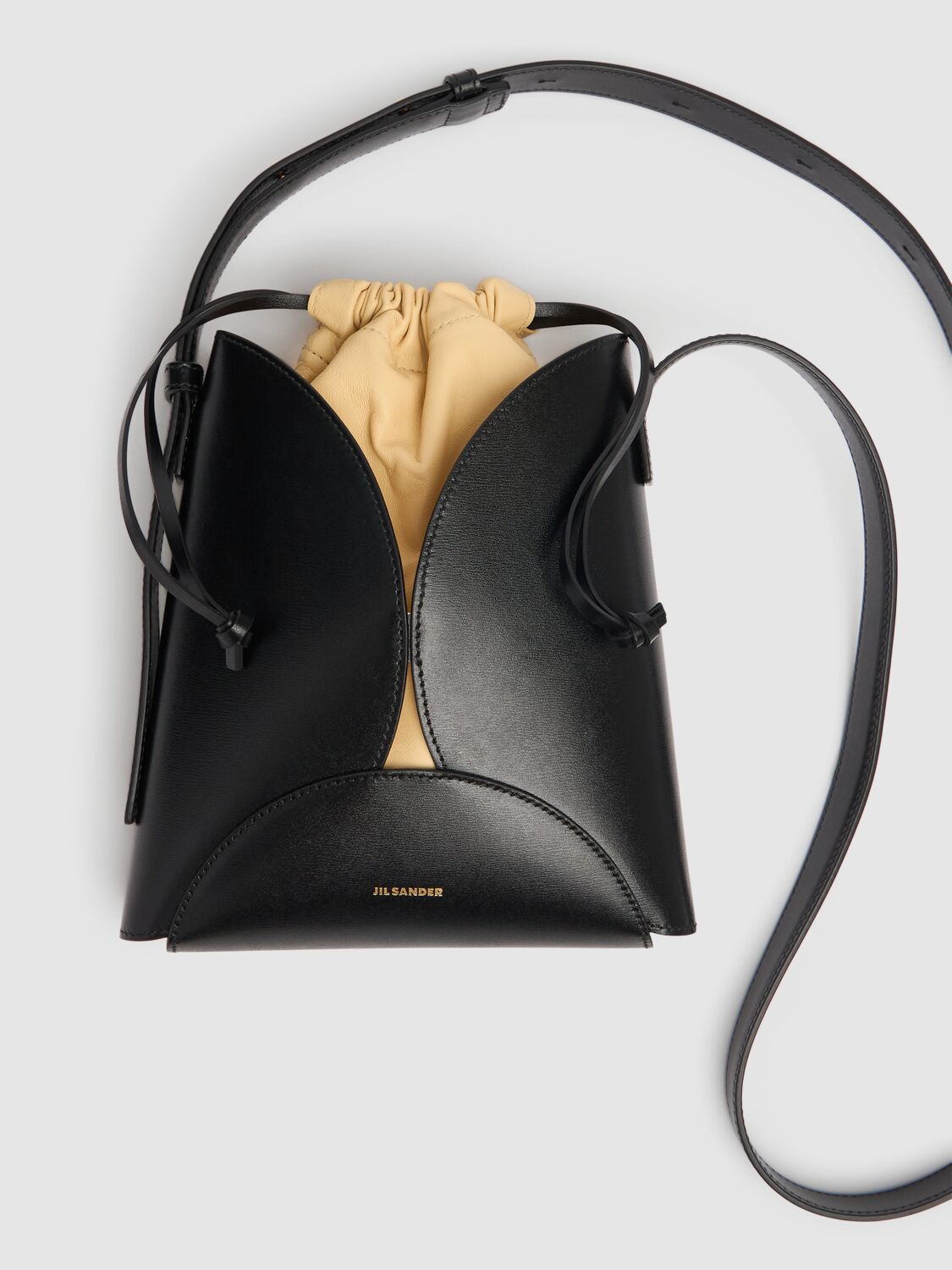 Shop Jil Sander Ellipse Palmellato Leather Crossbody Bag In Black