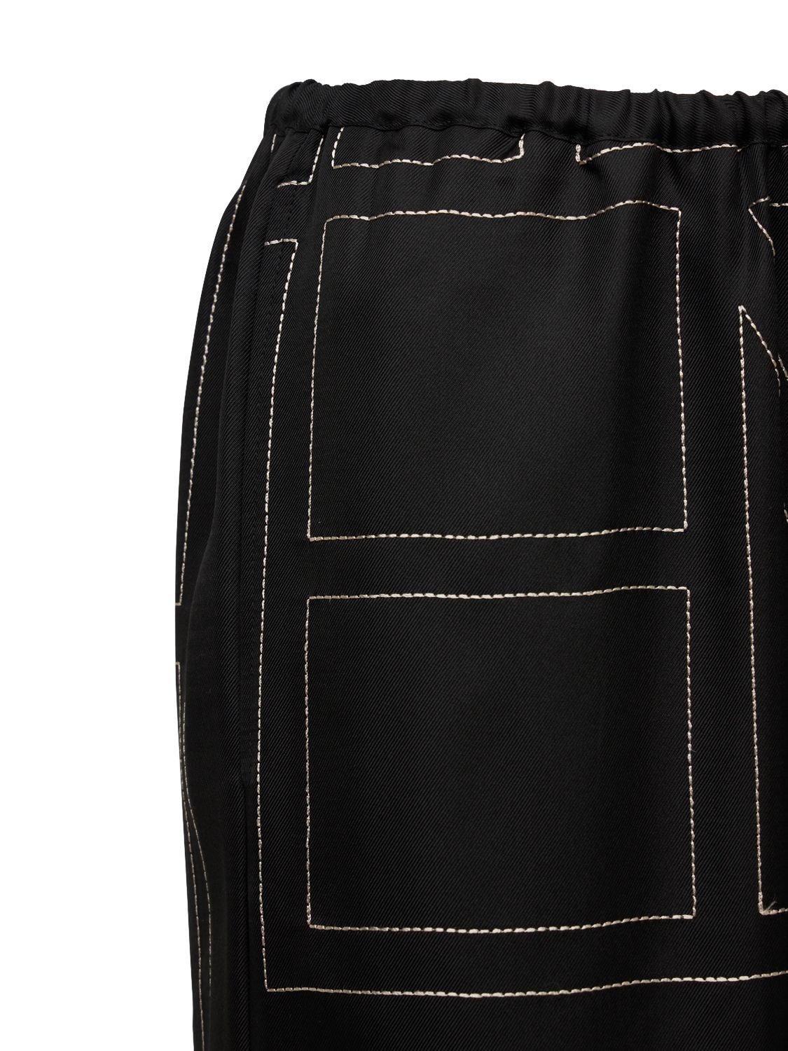 Shop Totême Monogram Embroidered Silk Pants In Black