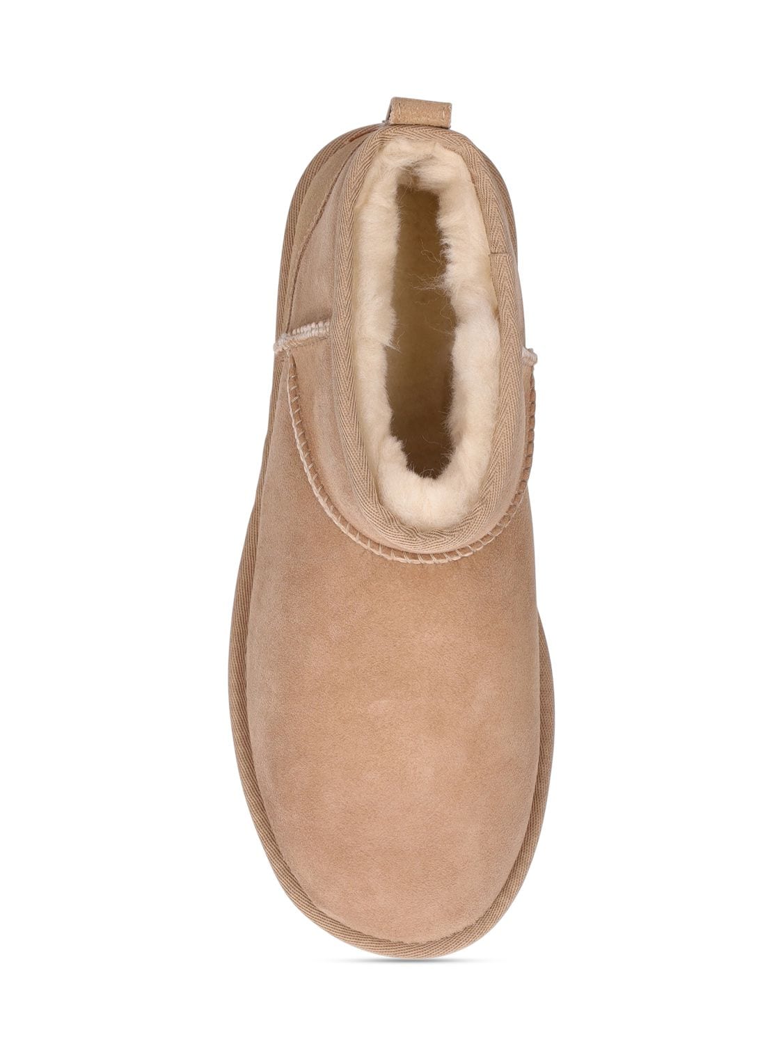 Shop Ugg 10mm Classic Ultra Mini Shearling Boots In Sand
