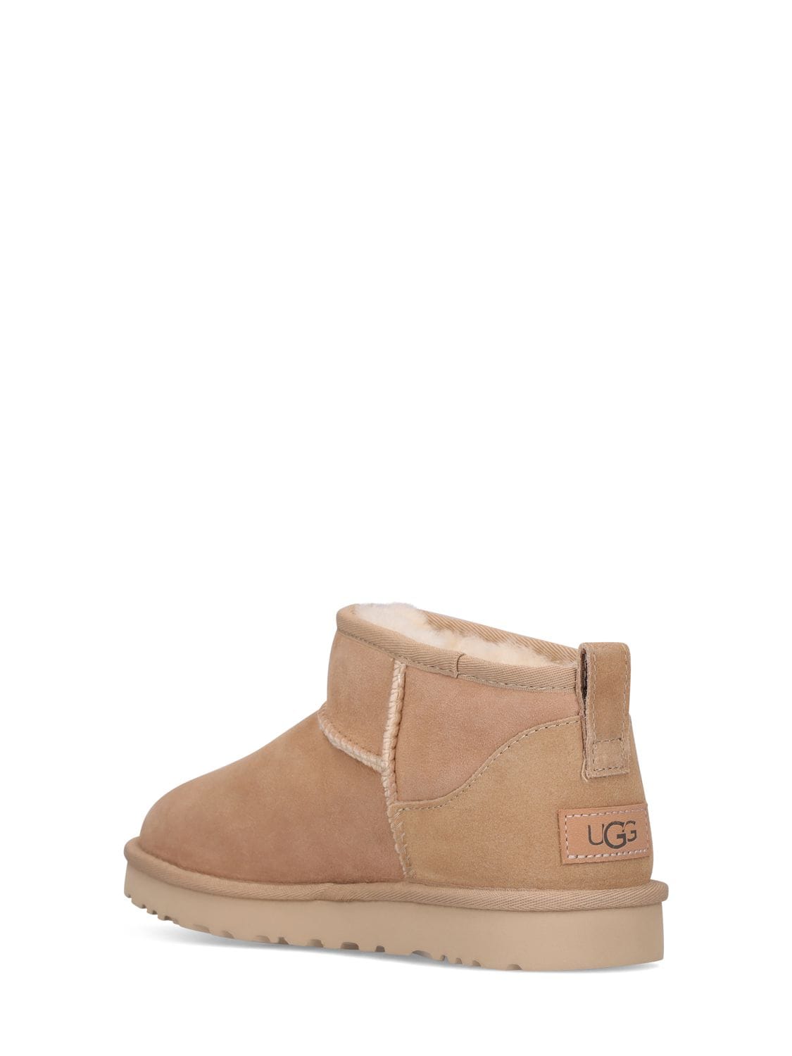 Shop Ugg 10mm Classic Ultra Mini Shearling Boots In Sand