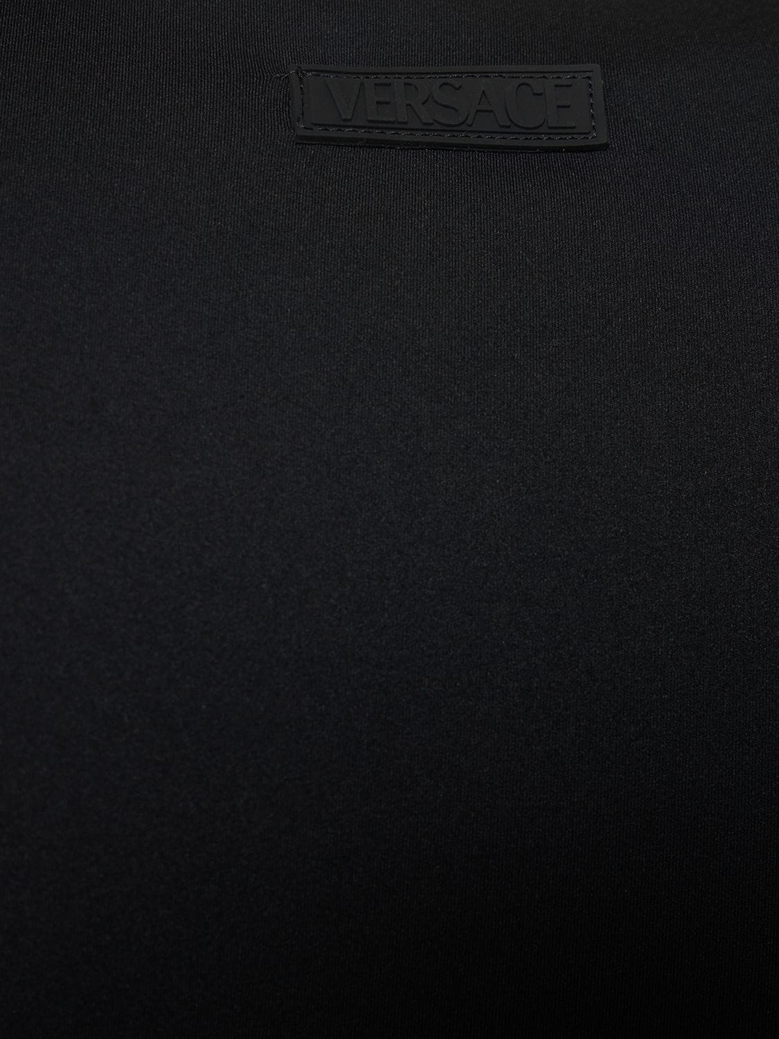 Shop Versace Long Sleeve Tech Jersey Crop Top In Black
