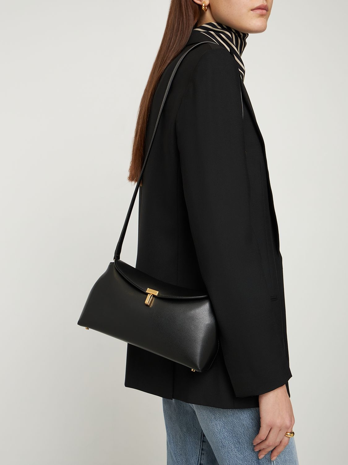 Shop Totême T-lock Pebble Leather Top Handle Bag In Black