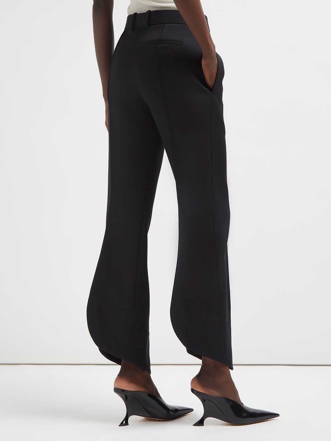 Bottega Veneta® Women's Curved Shape Wool Pants in Black. Shop online now.