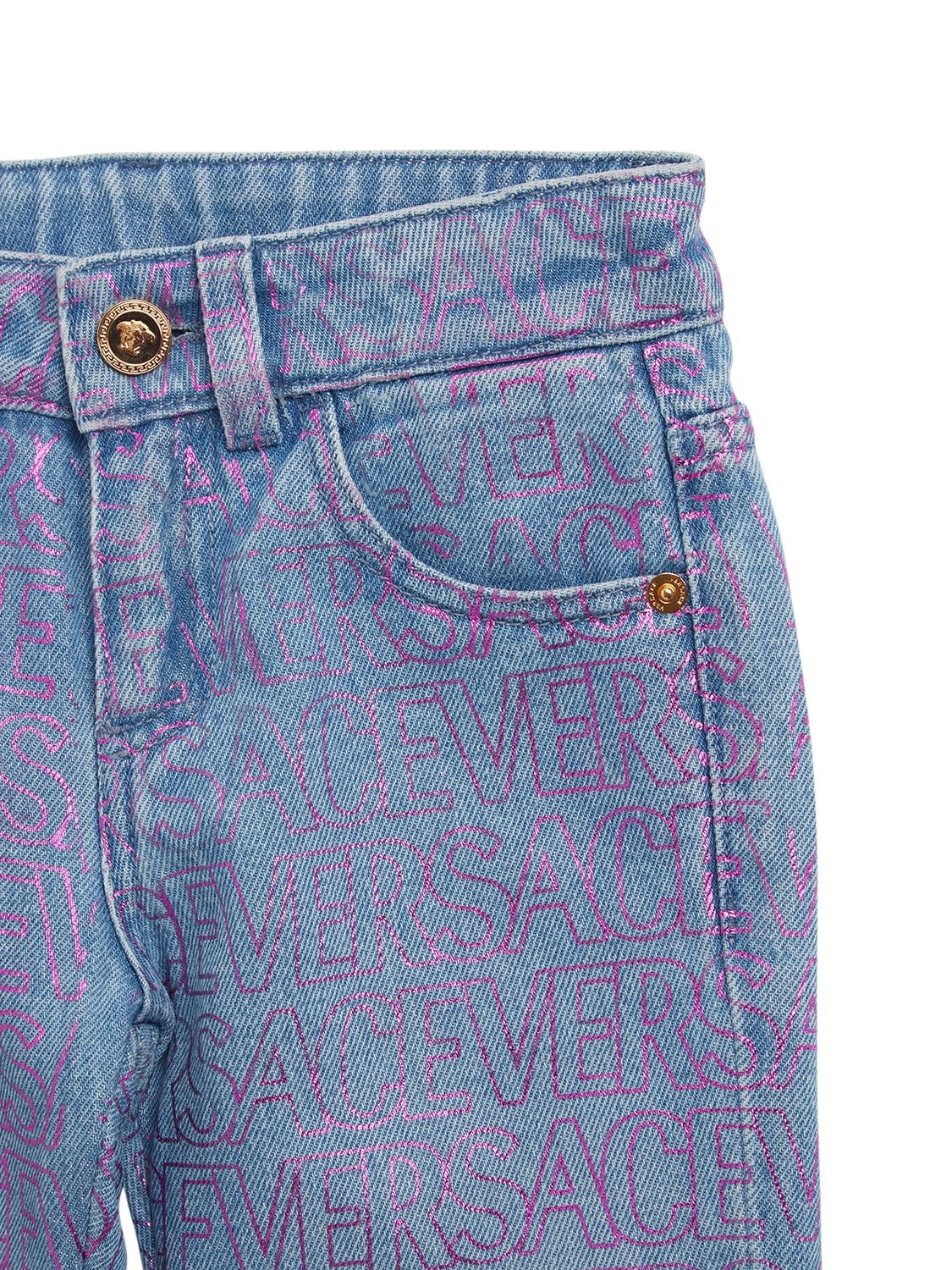 Shop Versace All Over Logo Print Cotton Denim Jeans