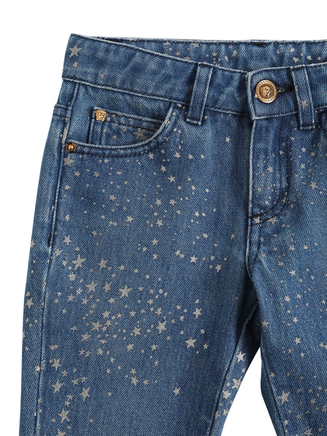 Shop Versace Glittered Cotton Denim Jeans