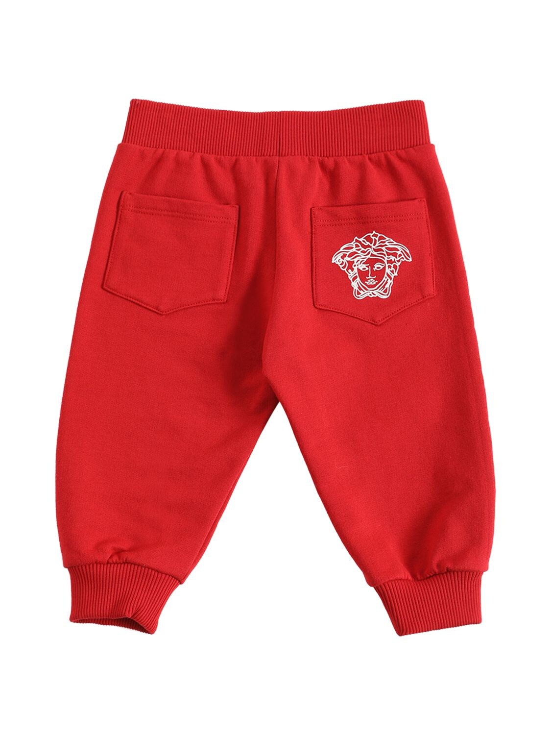 Shop Versace Greca Print Cotton Sweatpants In Red